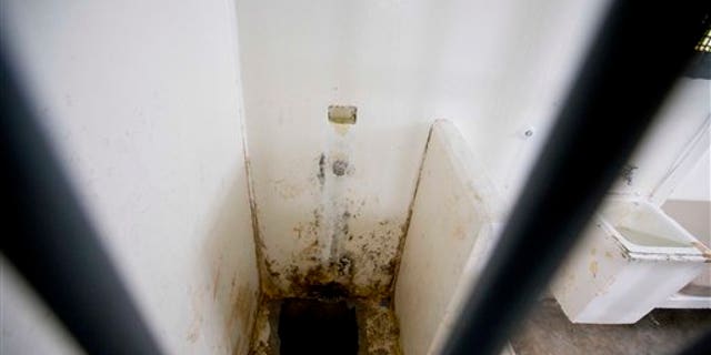 This photo shows the shower area and opening to a tunnel, where authorities claim drug lord Joaquin "El Chapo" Guzman, slipped into the tunnel to escape from his prison cell, at the Altiplano maximum security prison, in Almoloya, west of Mexico City, Wednesday, July 15, 2015. Experts have said the tunnel would have been more than a year in planning and building. The digging would have caused noise. The entrance was in a place beyond the view of security cameras at Mexico's toughest prison. They also said it was clear the escape by Mexico's most powerful drug lord must have involved inside help on a grand scale. (AP Photo/Eduardo Verdugo)