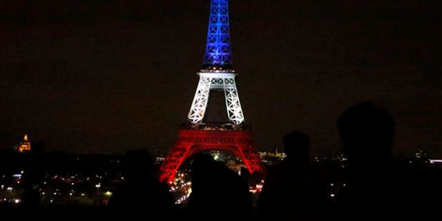 The Eiffel Tower lit up in the French national colors Monday.