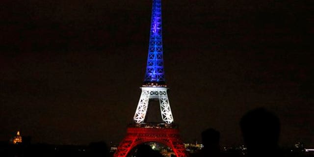 The Eiffel Tower lit up in the French national colors Monday.