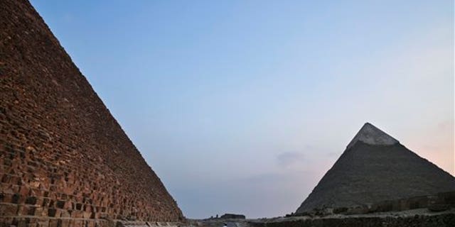 Gunmen on a motorcycle opened fire on a church near the Giza pyramids, state media report.