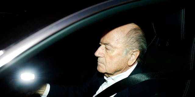 FILE - In this Sept. 29, 2015 file photo FIFA President Sepp Blatter drives his car into the garage of the FIFA headquarters on his way to work in Zurich, Switzerland (AP Photo/Michael Probst, file)