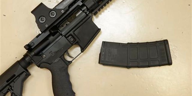 In this file photo, a custom-made semi-automatic hunting rifle with a high-capacity detachable magazine is displayed at TDS Guns in Rocklin, Calif. Calif. (AP Photo/Rich Pedroncelli)