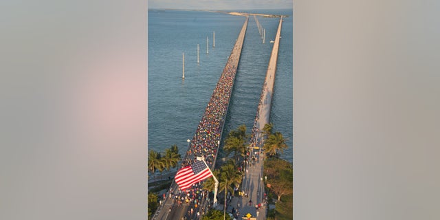 In this aerial photo provided by the Florida Keys News Bureau, runners go across the Seven-Mile Bridge Run Saturday, April 9, 2016, near Marathon, Fla., in the Florida Keys. (Andy Newman/Florida Keys News Bureau via AP)