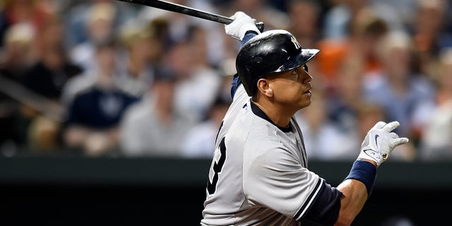 New York Yankees' Alex Rodriguez follows through on a two-run home run against the Baltimore Orioles during the sixth inning of a baseball game Saturday, June 13, 2015, in Baltimore. (AP Photo/Gail Burton)