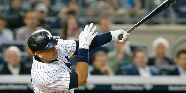 New York Yankees designated hitter Alex Rodriguez hits his 661st home run, surpassing Willie Mays for fourth on baseball's all-time home runs list, in a baseball game against the Baltimore Orioles at Yankee Stadium in New York, Thursday, May 7, 2015. (AP Photo/Kathy Willens)