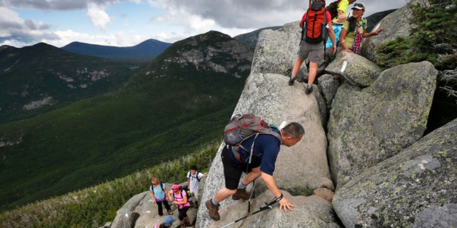 Aug. 7, 2015: Day-hikers scramble over rocky boulders on the Appalachian Trail below the summit of Mt. Katahdin in Baxter State Park in Maine. The sharp rise in the number people using the Appalachian Trail is causing headaches for officials, who say theyre dealing with increasing problems along the 2,189-mile footpath.