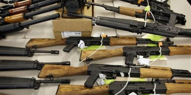 Jan. 25, 2011: A cache of seized weapons used in the ATF gun-running operation 'Fast and Furious' is displayed at a news conference in Phoenix.