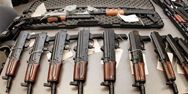 This 2008 file photo shows weapons seized by the Bureau of Alcohol, Tobacco, Firearms and Explosives (ATF), and laid out on a table at the bureau's Arizona headquarters in Phoenix.