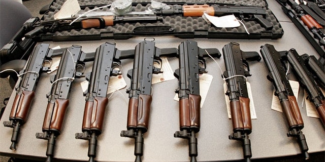 This 2008 file photo shows weapons seized by the Bureau of Alcohol, Tobacco, Firearms and Explosives (ATF), and laid out on a table at the bureau's Arizona headquarters in Phoenix.