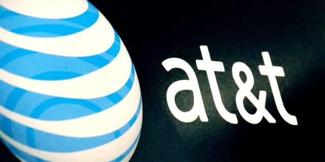 The AT&T logo is on display at a RadioShack store in Gloucester, Mass.