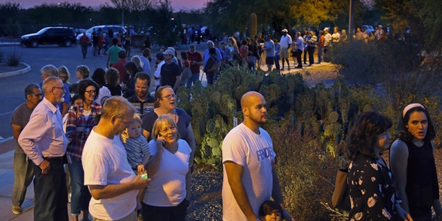 People wait in line to vote in the primary at the Environmental Education Center, Tuesday, March 22, 2016, in Chandler, Ariz. Residents in metro Phoenix have been bristling for years over a perception that state leaders want to make it harder for them to vote, and the mess at the polls Tuesday only heightened the frustration. (David Kadlubowski/The Arizona Republic via AP)