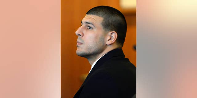 FILE - In this July 22, 2014, file photo, former New England Patriots' Aaron Hernandez watches during a hearing in Bristol County Superior Court in Fall River, Mass. Hernandez is charged with killing Odin Lloyd of Boston, whose body was found in an industrial park near Hernandez’s home in North Attleborough in June 2013. During a hearing Monday, Aug. 11, 2014, Judge E. Susan Garsh took under advisement a motion by his defense to suppress evidence from some electronic devices seized from the former NFL football player's home during the investigation. (AP Photo/CJ Gunther, Pool, File)