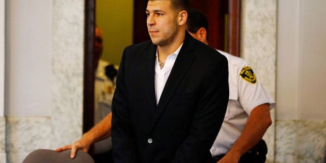 NORTH ATTLEBORO, MA - AUGUST 22: Aaron Hernandez is escorted into the courtroom of the Attleboro District Court for his hearing on August 22, 2013 in North Attleboro, Massachusetts. Former New England Patriot Aaron Hernandez has been indicted on a first-degree murder charge for the death of Odin Lloyd. (Photo by Jared Wickerham/Getty Images)
