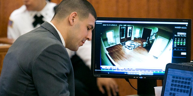 Hernandez takes notes during his murder trial in Fall River, Mass., on Wednesday, March 25, 2015.