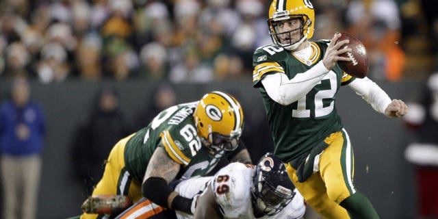 December 25, 2011: Green Bay Packers quarterback Aaron Rodgers scrambles during the second half of an NFL football game against the Chicago Bears in Green Bay, Wis.
