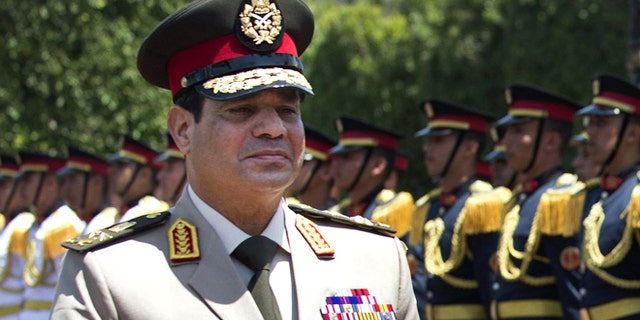 April 24, 2013: In this file photo, Egyptian Defense Minister Gen. Abdel-Fattah el-Sissi reviews honor guards during an arrival ceremony for his U.S. counterpart at the Ministry of Defense in Cairo. Egypt's military chief says he "can't turn his back" if the majority of Egyptians want him to run for president.