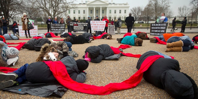 This Wednesday, Jan. 21, 2015 photo shows anti-abortion activists stage a "die-in" in front of the White House in Washington.