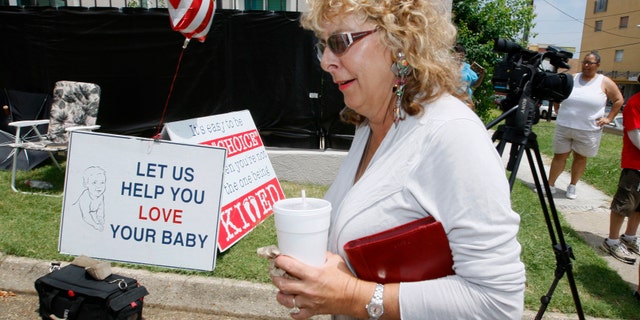 July 2- Jackson Women's Health Organization owner Diane Derzis, walks past abortion opponents protesting outside Mississippi's only abortion clinic in Jackson, Miss.