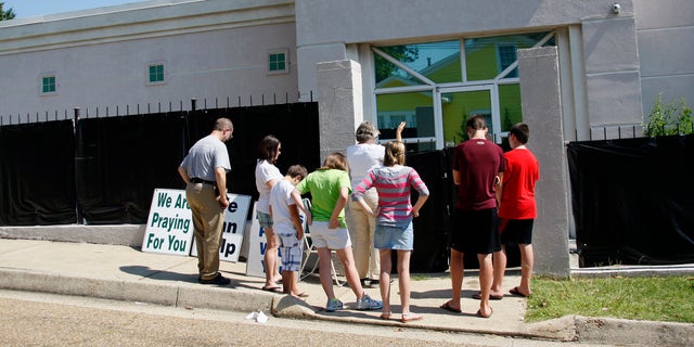 June 27, 2012: In this photograph, anti-abortion advocates stand outside Mississippi's only abortion clinic, singing and praying for their patients, and "counseling" them to reject abortion.
