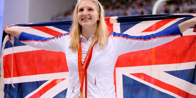 Aug. 16, 2008: In this file photo Britain's Rebecca Adlington shows her gold medal after the women's 800-meter freestyle semi-final during the swimming competitions in the National Aquatics Center at the Beijing 2008 Olympics.