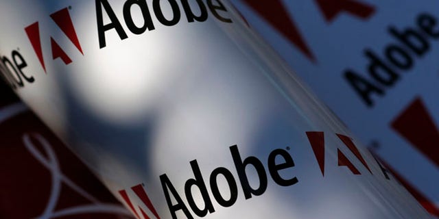 Adobe company logos are seen in this picture illustration taken in Vienna July 9, 2013. Picture taken July 9, 2013. To match Special Report TAX-BIGTECH/ REUTERS/Leonhard Foeger (AUSTRIA - Tags: BUSINESS SCIENCE TECHNOLOGY LOGO) - RTX11VPB
