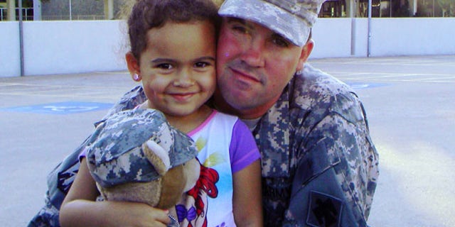 This July 21, 2013 file photo provided by Shannon Jones, attorney for biological father Dusten Brown, shows Brown with his daughter, Veronica, who has been at the center of an adoption dispute.