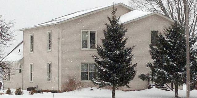 The house where a husband and wife lived with their four adopted children is shown, Wednesday, March 4, 2015, in Ashtabula, Ohio. The husband and wife pleaded not guilty to charges alleging they kept three adopted children locked in bedrooms most of the time and gave them little to eat. Prosecutors in Ashtabula County say the pair beat their two girls and their mentally challenged adult son. They were indicted last week on other charges. Prosecutors say the abuse occurred between September 2011 and September 2013. (AP Photo/Mark Gillispie)