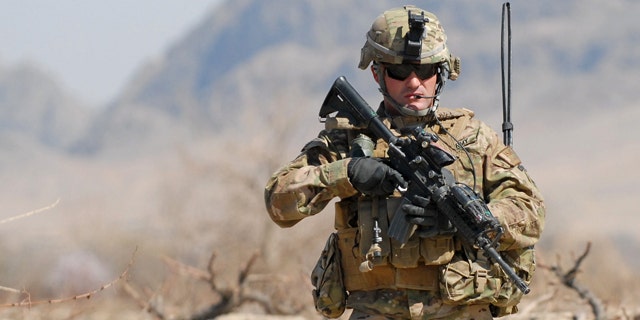 March 8, 2011: Army 1st Sgt. Raymond Dakos patrols near Combat Outpost Kowall in Kandahar, Afghanistan