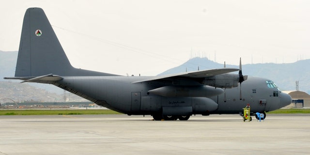 An Afghan Air Force C-130 sits on the flightline at Kabule Air Wing, Kabul International Airport, Kabul Afghanistan. The cargo plane is one of four that were provided to the Afghan Air Force with U.S. tax dollars.