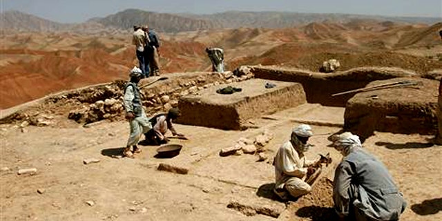 In 2008, Afghan archaeologists are seen digging the baked earth on the heights of Cheshm-e-Shafa in the Balkh province.