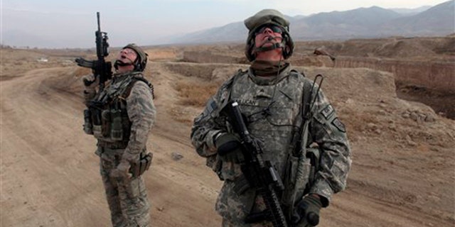 Nov. 30: U.S. troops, part of the Counter-Improvised Explosive Device route clearance unit, look up as U.S. fighter jets fly overhead near Wardak province, Afghanistan. (AP)