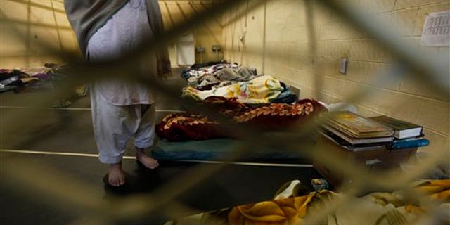 March 23: Afghan detainees seen through mesh wire fence inside the Parwan detention facility near Bagram Air Field in Afghanistan.