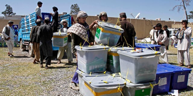 April 7, 2014 - Afghan election workers carry out a ballot box from a truck at the warehouse of the Independent Elections Commission in Kandahar, Afghanistan.