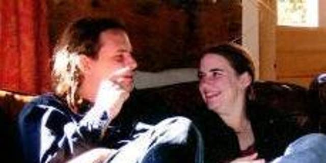 In this undated photo provided by James Coleman, Caitlan Coleman, right, sits with her husband, Josh. Caitlan Coleman's family has broken months of silence over her mysterious disappearance.