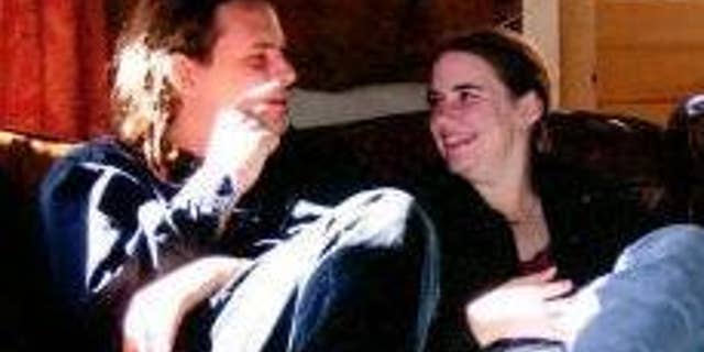 In this undated photo provided by James Coleman, Caitlan Coleman, right, sits with her husband, Josh. Caitlan Coleman's family has broken months of silence over her mysterious disappearance.