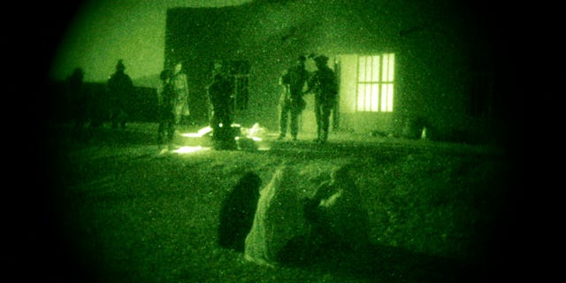 October 28, 2009: Afghan women and their children wait as U.S. Special Operations forces and Afghan National Army soldiers search their home during a joint operation targeting insurgents operating in Afghanistan's Farah province. Increased nighttime military raids by international military forces in Afghanistan have created a resentment that has undercut any battlefield gains from the tactic, according to a September 19 report by a U.S. think tank.