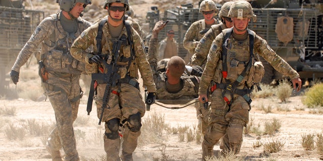 June 17, 2011: U.S. Army Pfc. Shawn Williams of the 1st Stryker Brigade Combat Team, 25th Infantry Division based in Fort Wainwright, Alaska, gives the thumbs-up to members of his unit as he is evacuated after being injured by a roadside bomb.