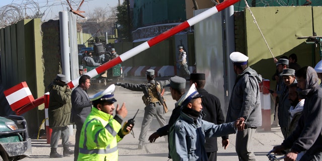Nov. 9, 2014: Afghan Police inspect the site of a suicide attack in Kabul. A bomb exploded on Sunday morning at the police headquarters, killing at least one officer and wounding another six, officials said. (AP Photo/Rahmat Gul)