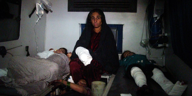 Dec. 31, 2014: Injured Afghan children are treated at a hospital in Helmand province, south of Kabul. A rocket fired amid fighting between Taliban insurgents and Afghan soldiers killed at least 26 people at a nearby wedding party Thursday night, authorities said, a grim end to a year that saw the end of the 13-year U.S.-led combat mission there. (AP Photo/Abdul Khaliq)