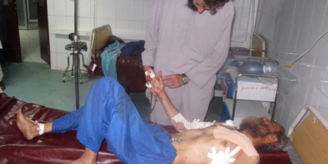 July 13, 2015: An Afghan man lies on a bed at a hospital after being injured at a suicide attack at Khost province eastern of Kabul. (AP Photo/Nishanuddin Khan)