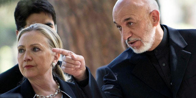 July 7, 2012: U.S. Secretary of State Hillary Rodham Clinton, left, walks with Afghanistan President Hamid Karzai to a news conference at the Presidential Palace in Kabul.