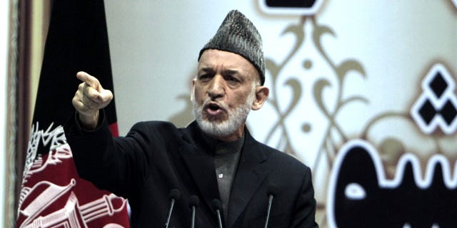 November 24, 2013: Afghan President Hamid Karzai speaks during the last day of the national consultative council known as a Loya Jirga in Kabul, Afghanistan. Afghanistan's president says he won't immediately sign a security deal with the United States, ignoring a recommendation by an assembly of Afghan elders and leaders that he do so by the end of the year. (AP Photo/Rahmat Gul)
