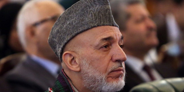 September 23, 2014: Afghan President Hamid Karzai attends his farewell ceremony at the presidential palace in Kabul. (AP Photo/Rahmat Gul)