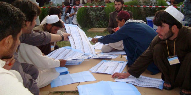 Sept. 20, 2010: Election workers count votes at the regional counting center in Khost, Afghanistan.