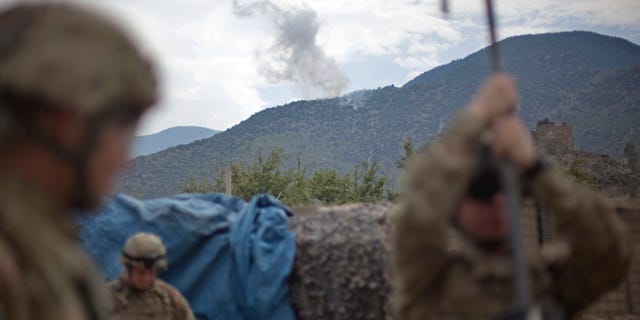Smoke rises from an insurgent fighting position after being hit with a 120mm high explosive mortar round fired by soldiers with the U.S. Army's Bravo Company of the 25th Infantry Division, 3rd Brigade Combat Team, 2nd Battalion 27th Infantry Regiment based in Schofield Barracks, Hawaii, Friday, Sept. 9, 2011 at Combat Outpost Monti in Kunar province, Afghanistan.