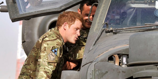 July 9, 2012 - FILE Photo of Britain's Prince Harry examining the cockpit of an Apache helicopter at Camp Bastion in Afghanistan.