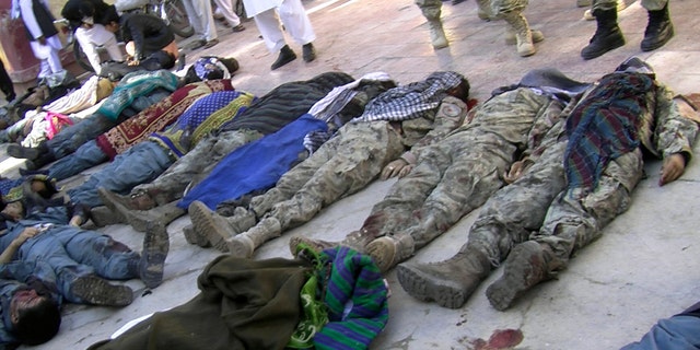 Oct. 26, 2012 - Bodies of victims of a suicide attack lie in a courtyard of a hospital in Maymana, northwest of Kabul, Afghanistan.