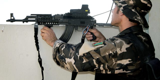 July 9, 2012- An Afghan security man aims his weapon towards Taliban militants, not pictured, during a gun battle in Kandahar, south of Kabul, Afghanistan.