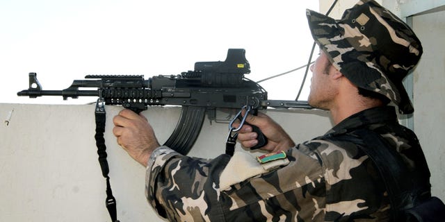 July 9, 2012- An Afghan security man aims his weapon towards Taliban militants, not pictured, during a gun battle in Kandahar, south of Kabul, Afghanistan.