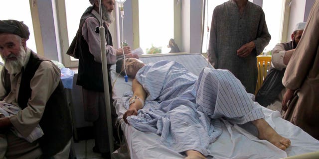 June 25: An injured Afghan man, a victim of a blast lies in a hospital bed in Kunduz city in the northern province of Kunduz, Afghanistan. A bicycle rigged with explosives ripped through a bazaar in the Khanabad district of Kunduz province on Friday, killing at least 10 people, including a police officer. At least 24 people were wounded in the attack, according to an Interior Ministry statement.